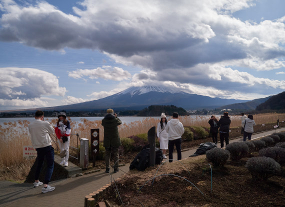 ('Tourists admire Mount Fuji by the shores of Kawaguchi Lake in Yamanashi Prefecture, Japan. Xinhua News Agency Information Map',)